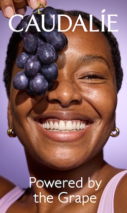 caudlie. powered by the grape. image of model holding grapes.