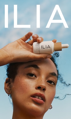 Ilia. Image of model holding product.