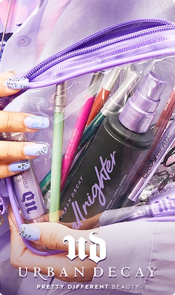 UD | Urban Decay. Pretty Different Beauty. Hand holding clear bag of products.